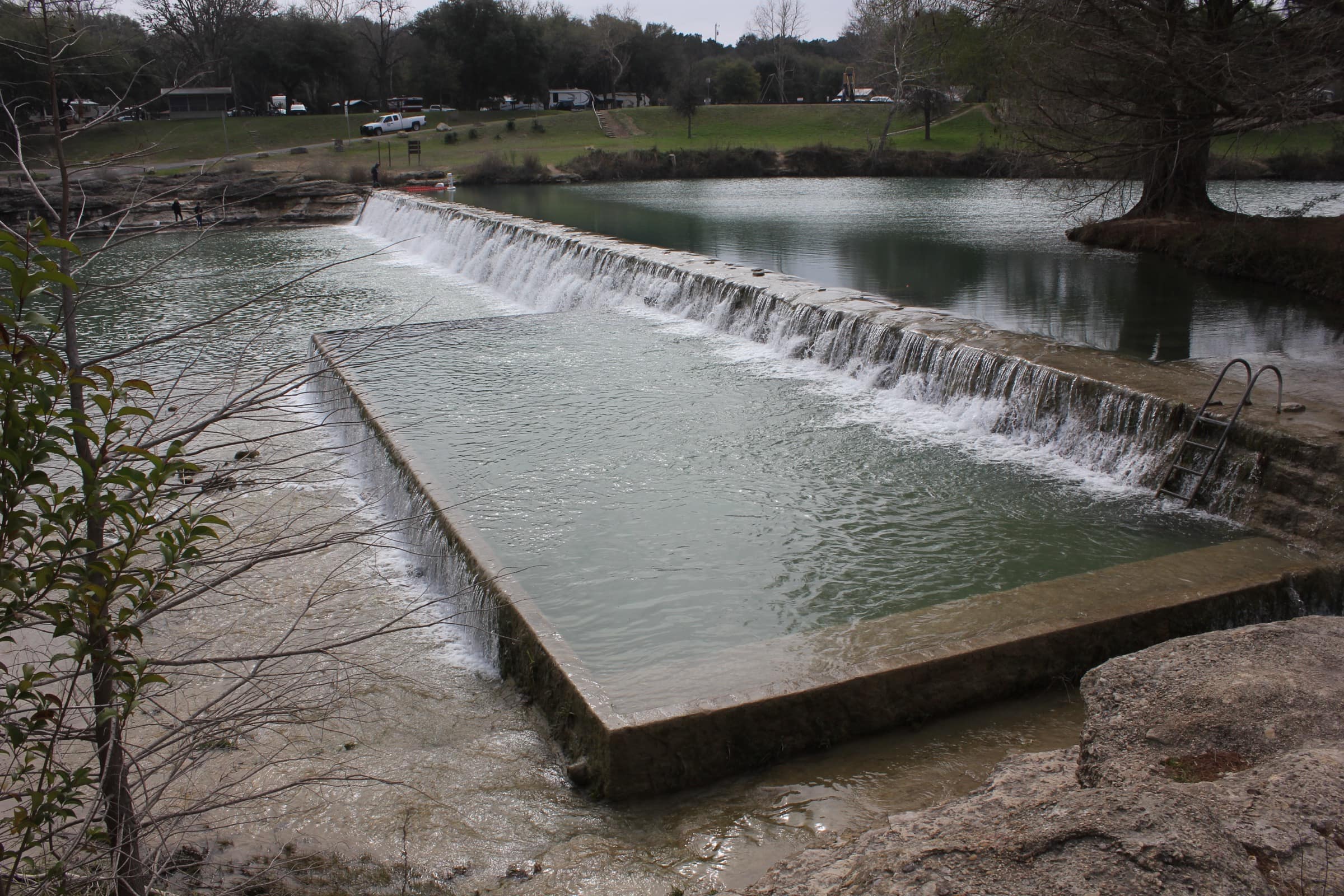 Water pouring over the 1930s CCC dam on the Blanco River in Blanco State Park